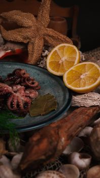 A close-up of a gourmet octopus dish with lemon slices, presented in a rustic setting.