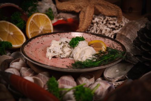 Free Close-up of a delicious seafood dish garnished with parsley and lemon slices. Stock Photo
