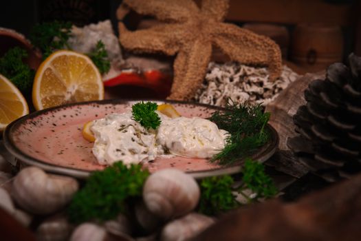 A gourmet seafood dish with creamy sauce garnished with dill and lemon, perfect for food photography.