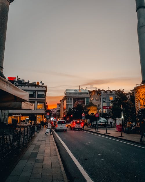 Cars on Street in Town at Sunset