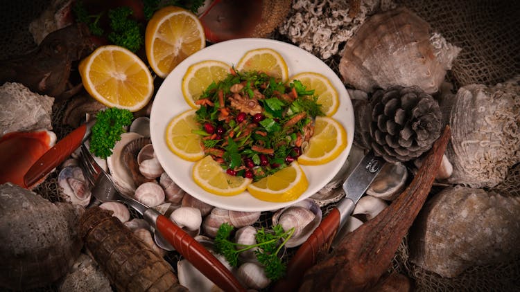 Plate Of Meat With Herbs And Lemons