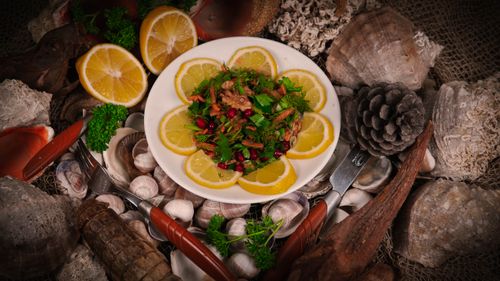 Free A vibrant seafood salad garnished with lemon and herbs, perfect for culinary inspiration. Stock Photo