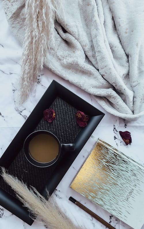 Coffee in Cup and Notebook on Table