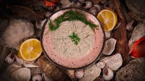Free Delicious seafood mousse garnished with dill, surrounded by seashells and lemon slices. Stock Photo