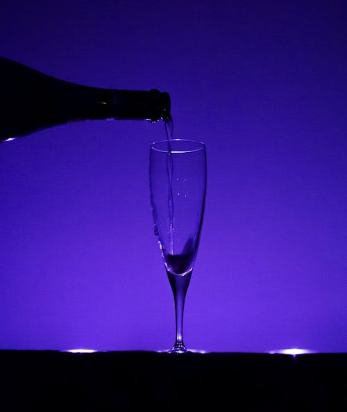 A Silhouette of an Champagne being Poured