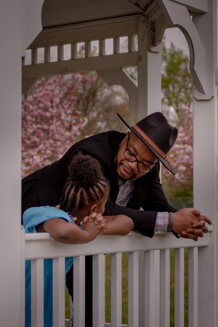 Man Talking To Little Girl On The Porch