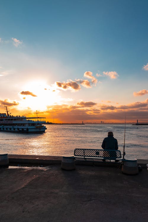 Back View of a Person Sitting at the Beach