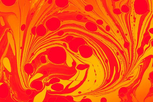 Colorful abstract red and yellow swirl pattern with circular designs, perfect for vibrant backgrounds.