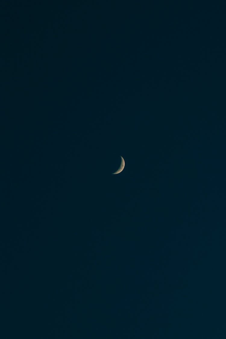 A Crescent Moon In The Night Sky 