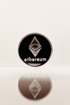 A shiny Ethereum coin with a reflection on a smooth surface, symbolizing digital currency.