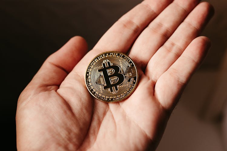 Close Up Of Bitcoin Crypto Currency Coin On Hand