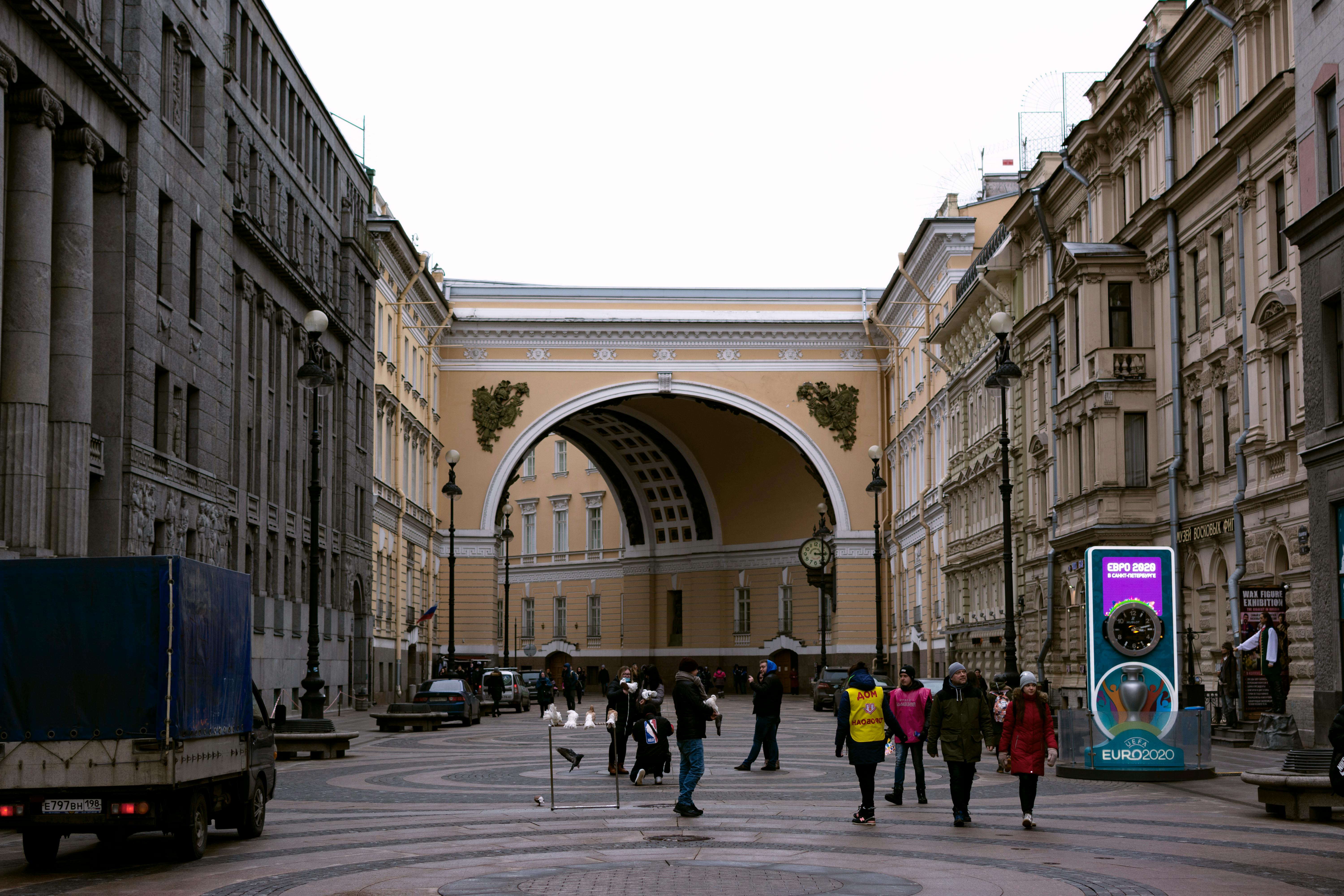 Saint Petersburg street scene featuring the iconic arch and pedestrians.