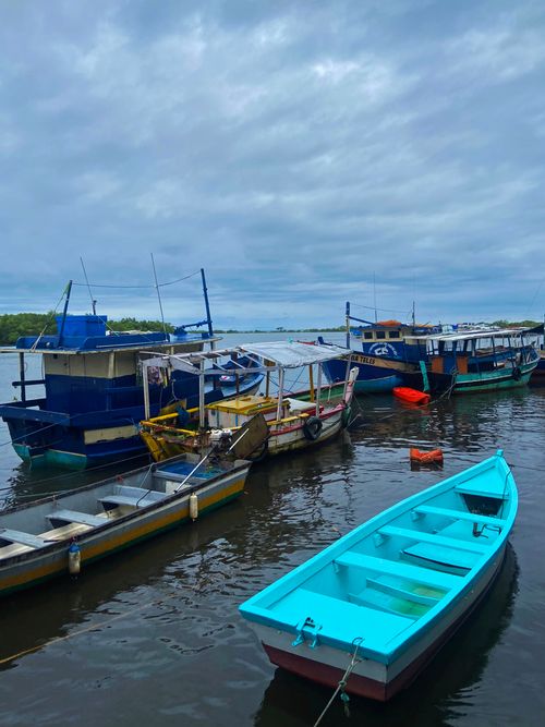 Free Vibrant fishing boats at rest in the calm waters of Santa Cruz Cabrália's scenic harbor. Stock Photo