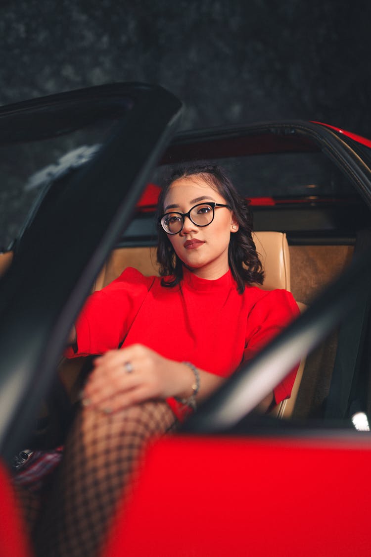 Cute Girl Sitting In Red Car