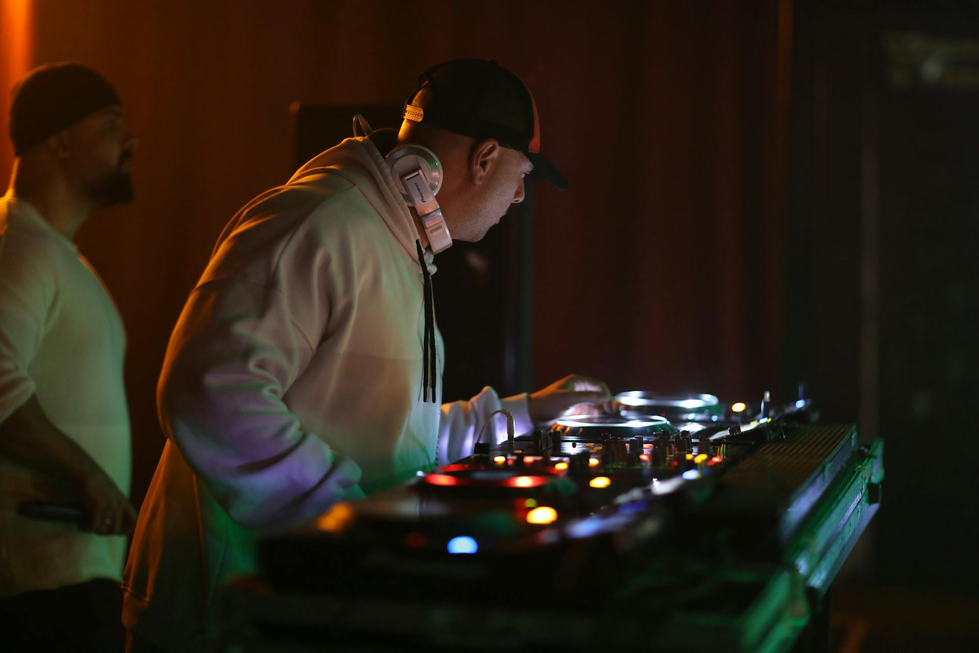 Close-up of a DJ skillfully mixing music on professional equipment at a club.