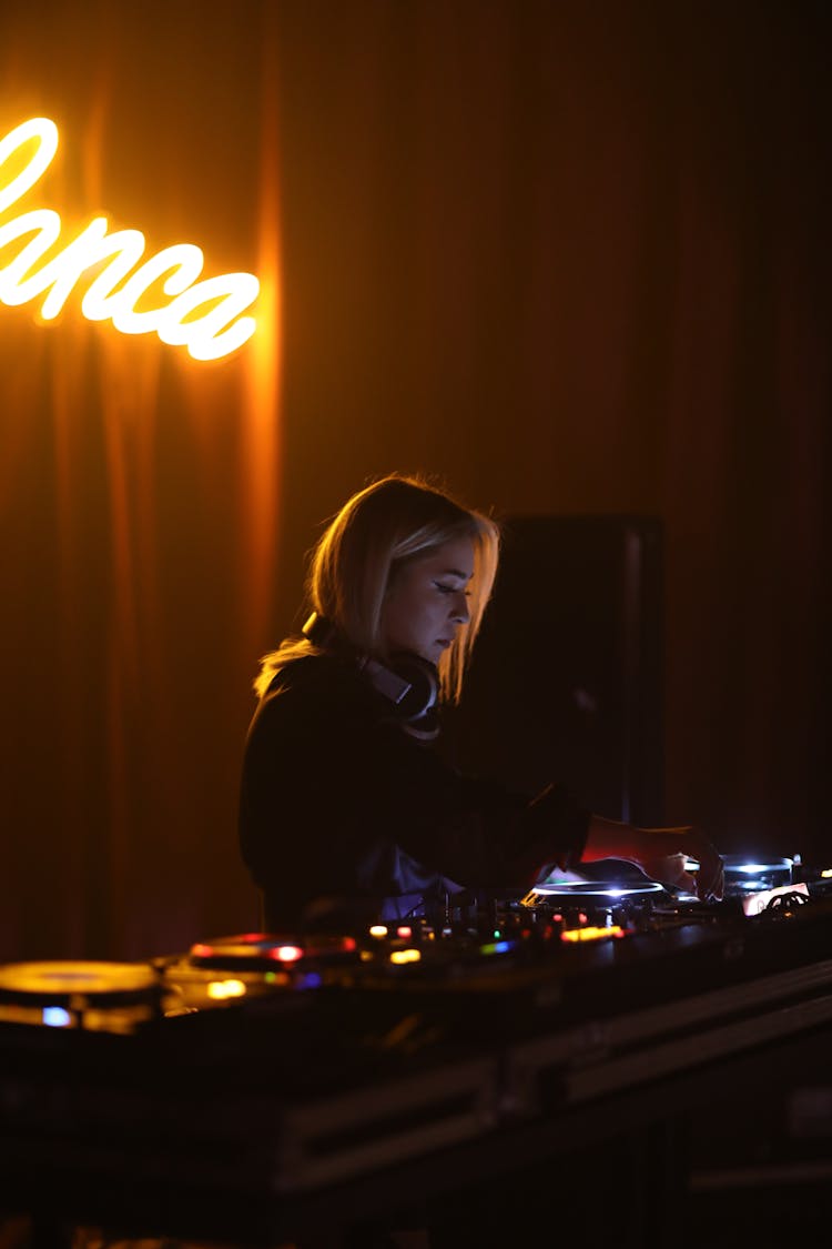 Woman Disc Jockey Playing Music With An Audio Mixer