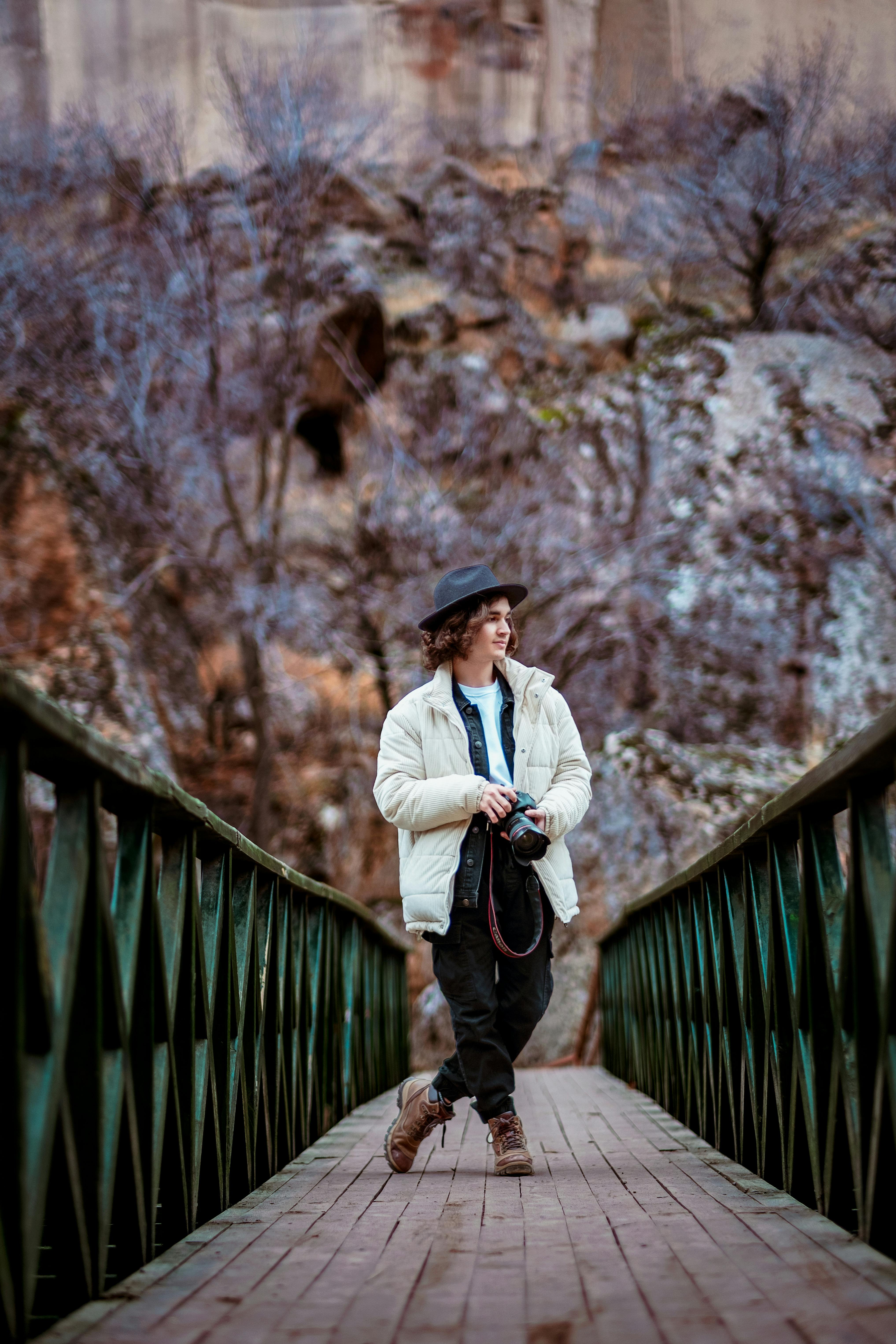 boy in hat with camera in hands