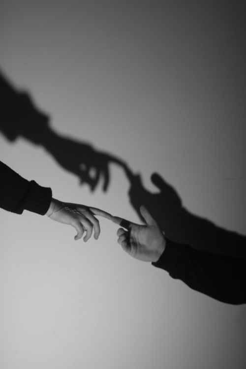 Free Artistic black and white photo of two hands reaching towards each other, highlighting connection and touch. Stock Photo