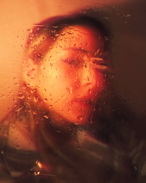 Free Woman Behind Wet Glass Panel Stock Photo