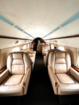 Elegant interior of a private jet showcasing luxurious leather seating for exclusive travel experience.