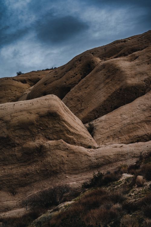 Free A captivating view of rugged rocky formations under a dramatic cloudy sky, showcasing nature's raw beauty. Stock Photo