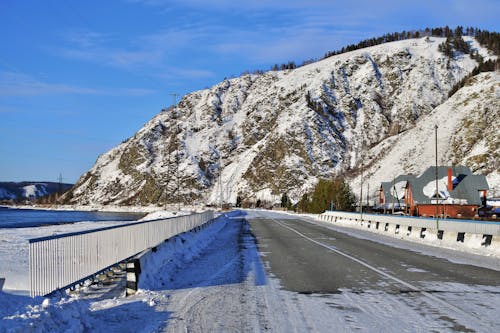 Free Asphalt Road Near Snow Covered Mountain Stock Photo