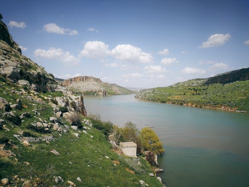 River between Green Hills during Daytime