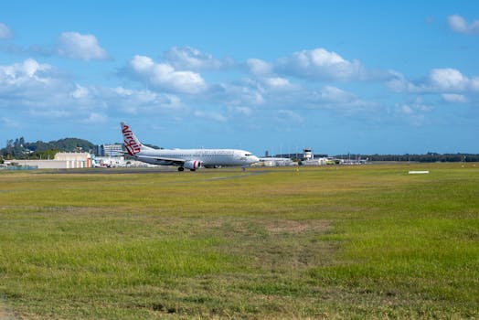 Virgin aircraft on the runway at Gold Coast Airport, Bilinga, Australia under a clear blue sky.