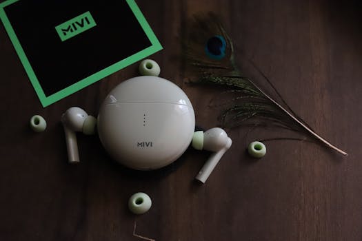 Stylish Mivi wireless earphones elegantly laid out on a wooden table with a peacock feather and accessories.