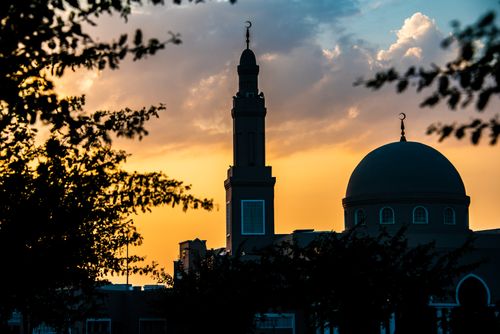 Free Silhouette of a mosque and minaret with a dramatic sunset sky in Dubai, UAE. Stock Photo