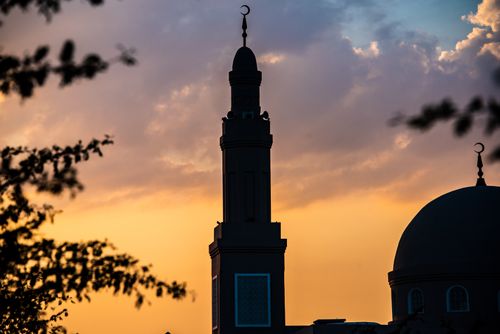 Free Silhouette of a mosque minaret against a vibrant sunset sky in Dubai, United Arab Emirates. Stock Photo