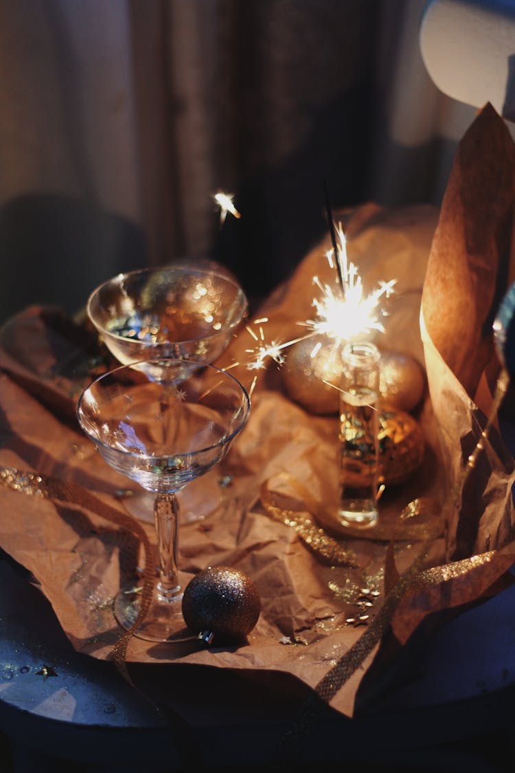 Champagne And Lit Sparkler For New Year Eve Celebration