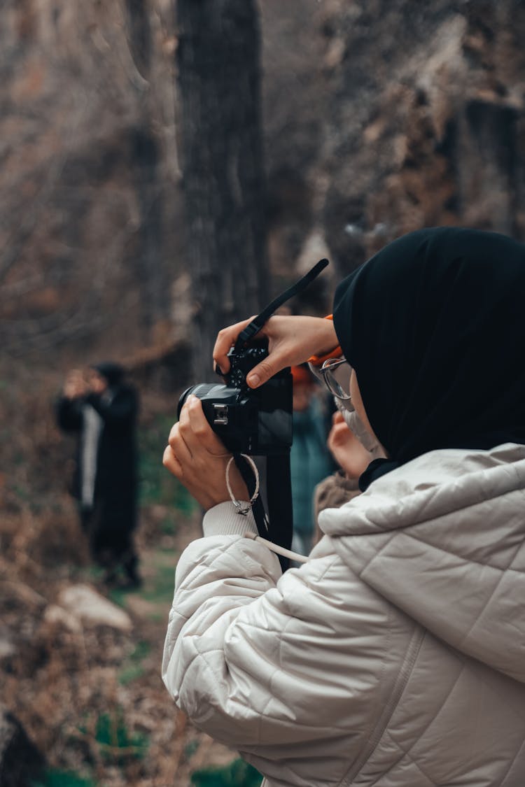 Photo Of A Woman Using A Black Camera