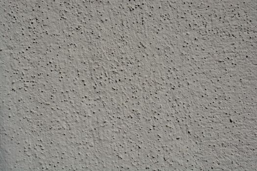 A close-up view showcasing the intricate texture of a gray stucco wall, perfect for backgrounds.