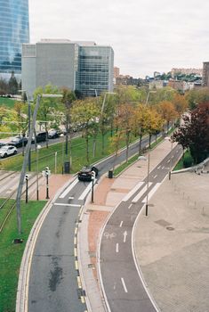 A picturesque view of modern buildings and bicycle paths in autumn, Bilbao, Spain.
