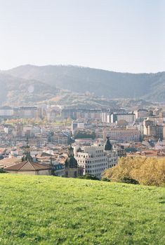 Explore the picturesque cityscape of Bilbao, Spain with its hills and historic architecture.