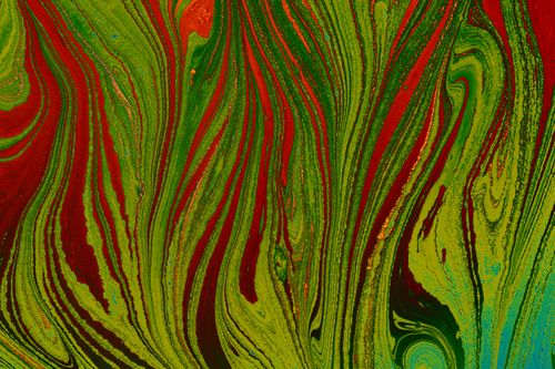 Free Dynamic and colorful marbled pattern with red and green swirls, capturing abstract art's vibrant essence. Stock Photo