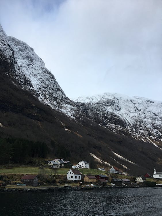 Photo of a Village with a View of the Snow-Capped Mountain 