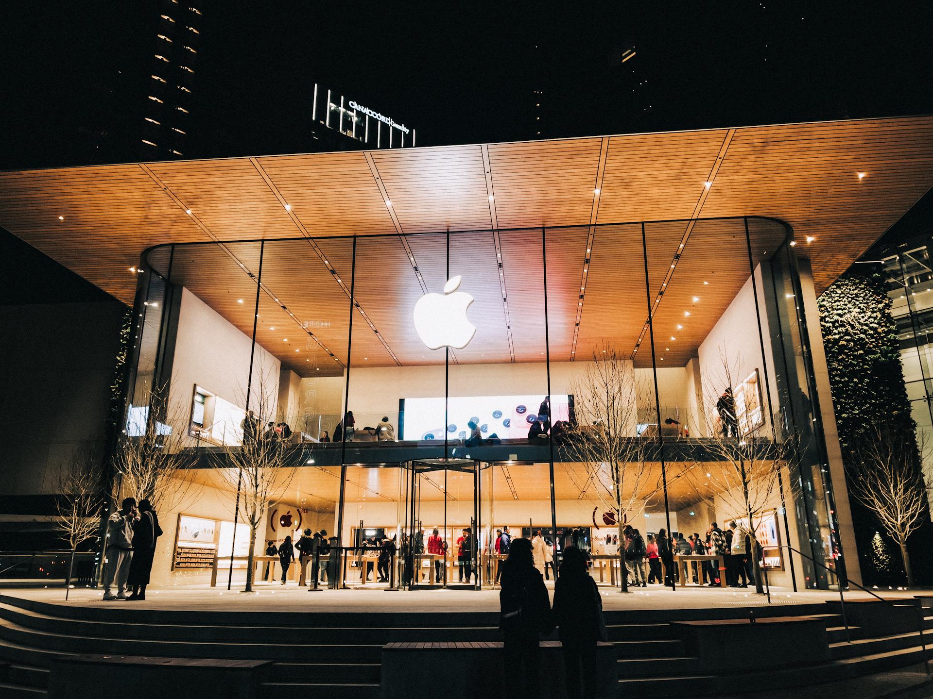 Vibrant night scene of an Apple Store in Vancouver, highlighting modern architecture and urban lifestyle.