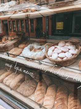 A tempting showcase of artisan breads and pastries in a Riga bakery window.