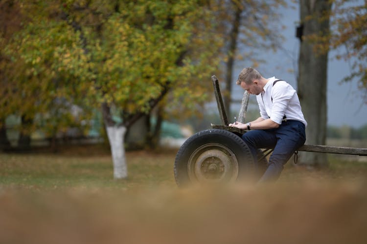 A Man In White Long Sleeves Writing A Letter