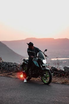 A man on a sports bike enjoys a scenic sunset view in Kasbe Vani, India.
