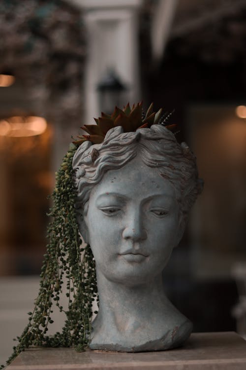 Photo of a Stone Sculpture of a Woman Head