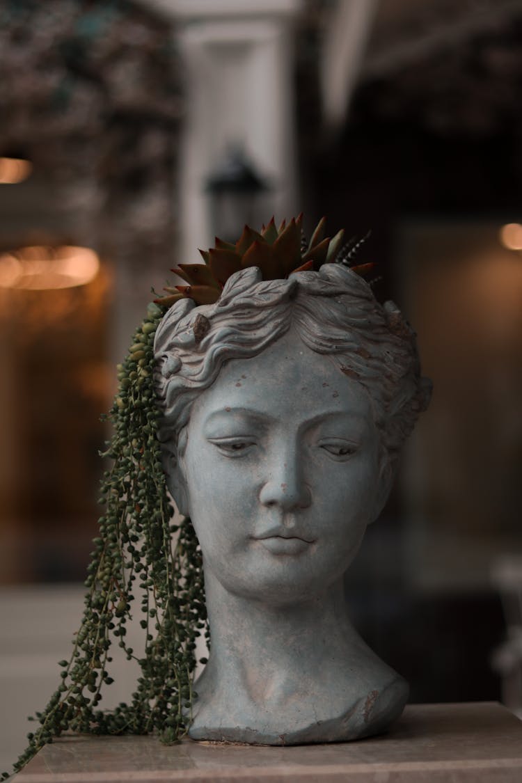 Photo Of A Stone Sculpture Of A Woman Head