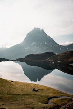 Capture of Pic du Midi d'Ossau reflecting in Lake Gentau, showcasing stunning mountain scenery.