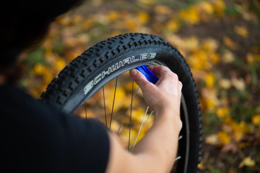 A Person Fixing a Bicycle Tire