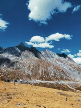 Stunning view of rugged mountain peaks under a vibrant blue sky, showcasing nature's grandeur.
