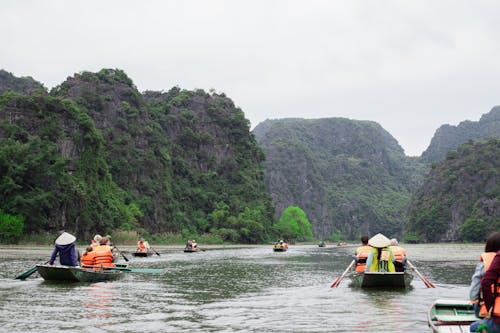 People Riding a Boat on River
