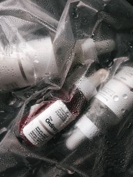 Close-up of skincare serums and bottles in a moist setting, showcasing The Ordinary products.