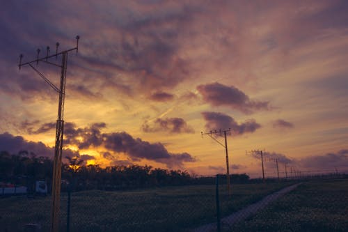 Lamp Posts on the Field During Sunset
